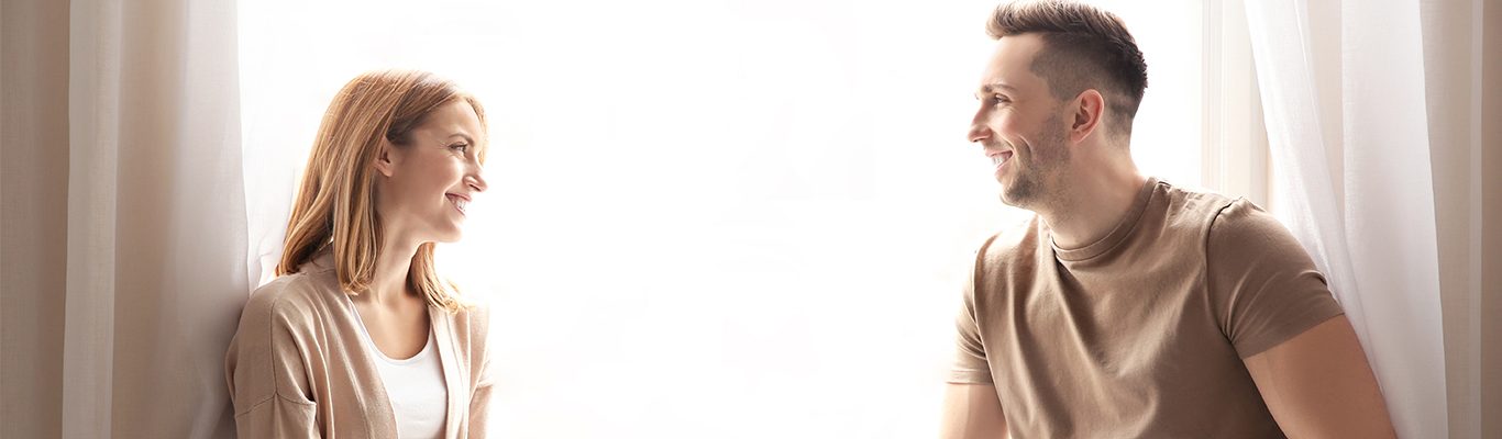 A picture of a smiling couple discussing their recent home loans