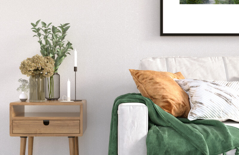 Couch with green blanket and table with vases