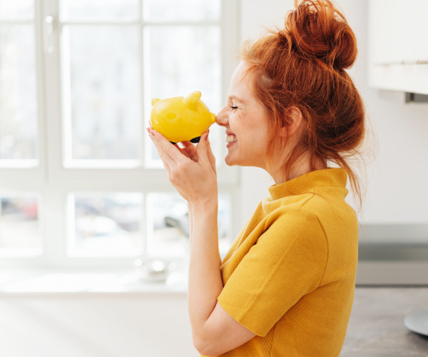 Woman with yellow pig bank
